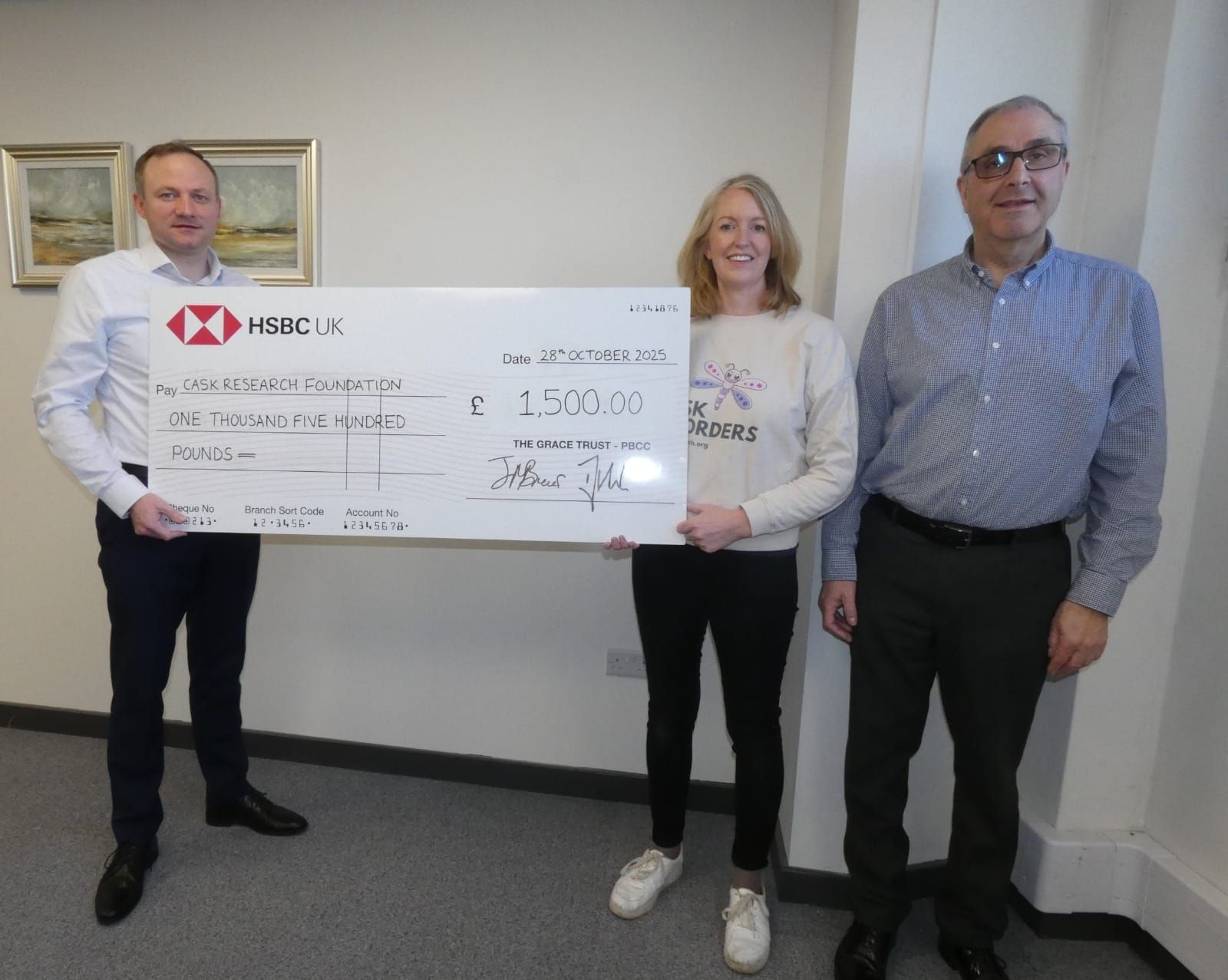 Laura receiving a giant cheque
