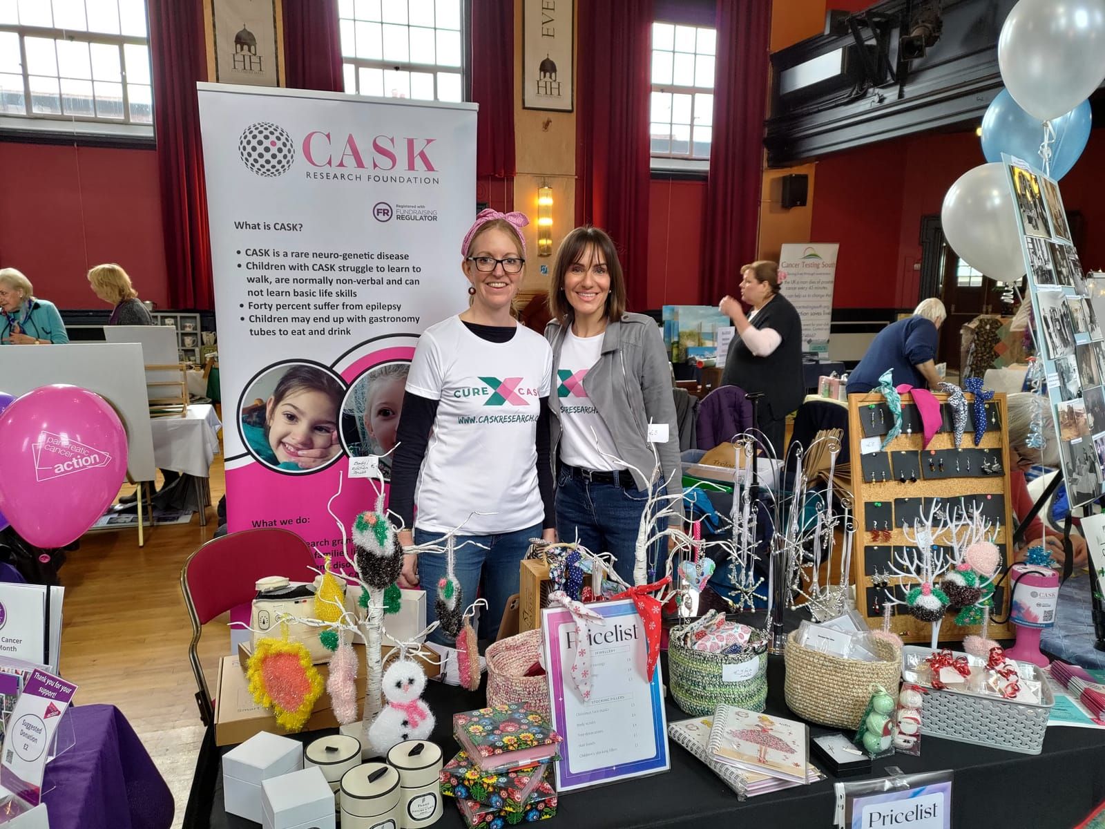 Volunteers at a Christmas fair fundraising for CASK Research