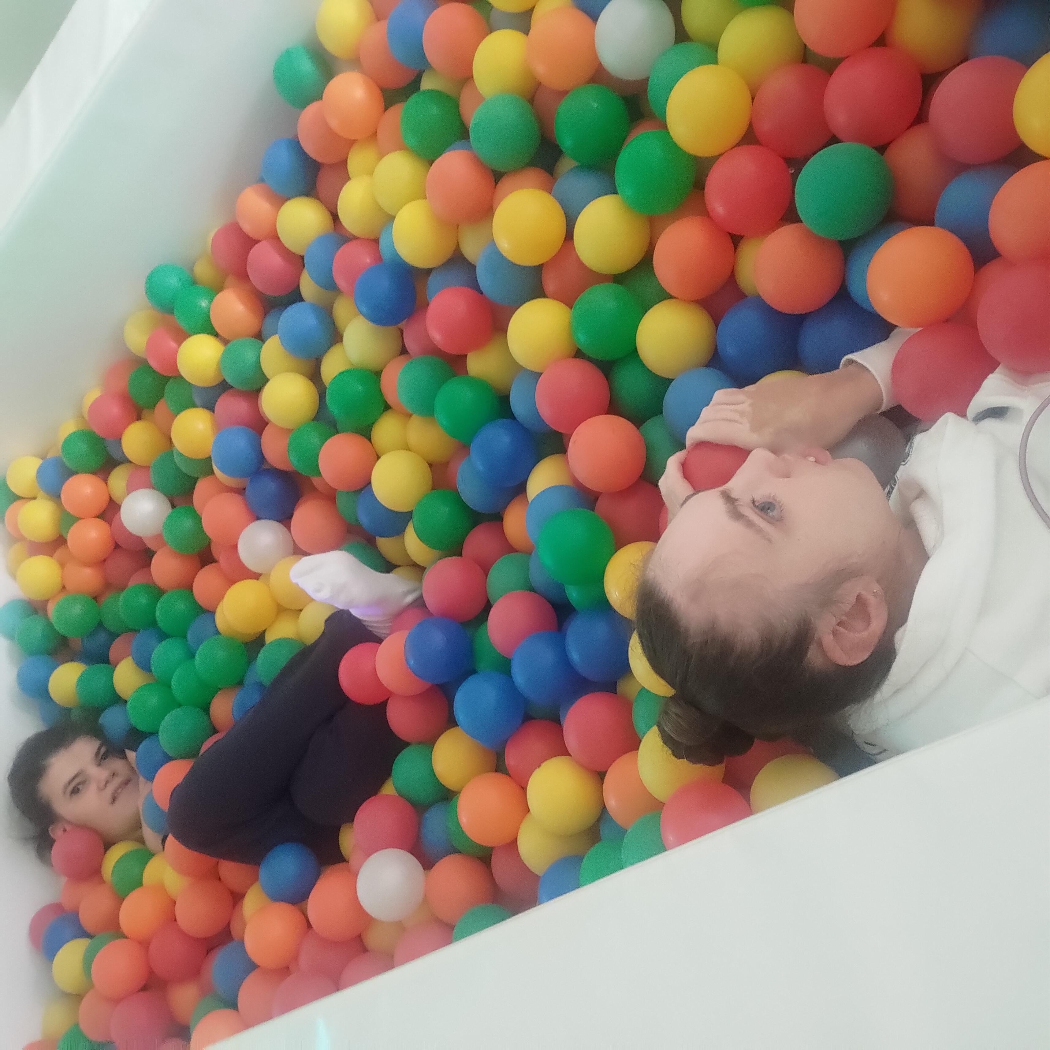 A child playing in a ball pit